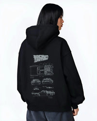 Black hoodie worn by a female model, back view, featuring DeLorean DMC-12 street retro racing performance motorsport graphic.