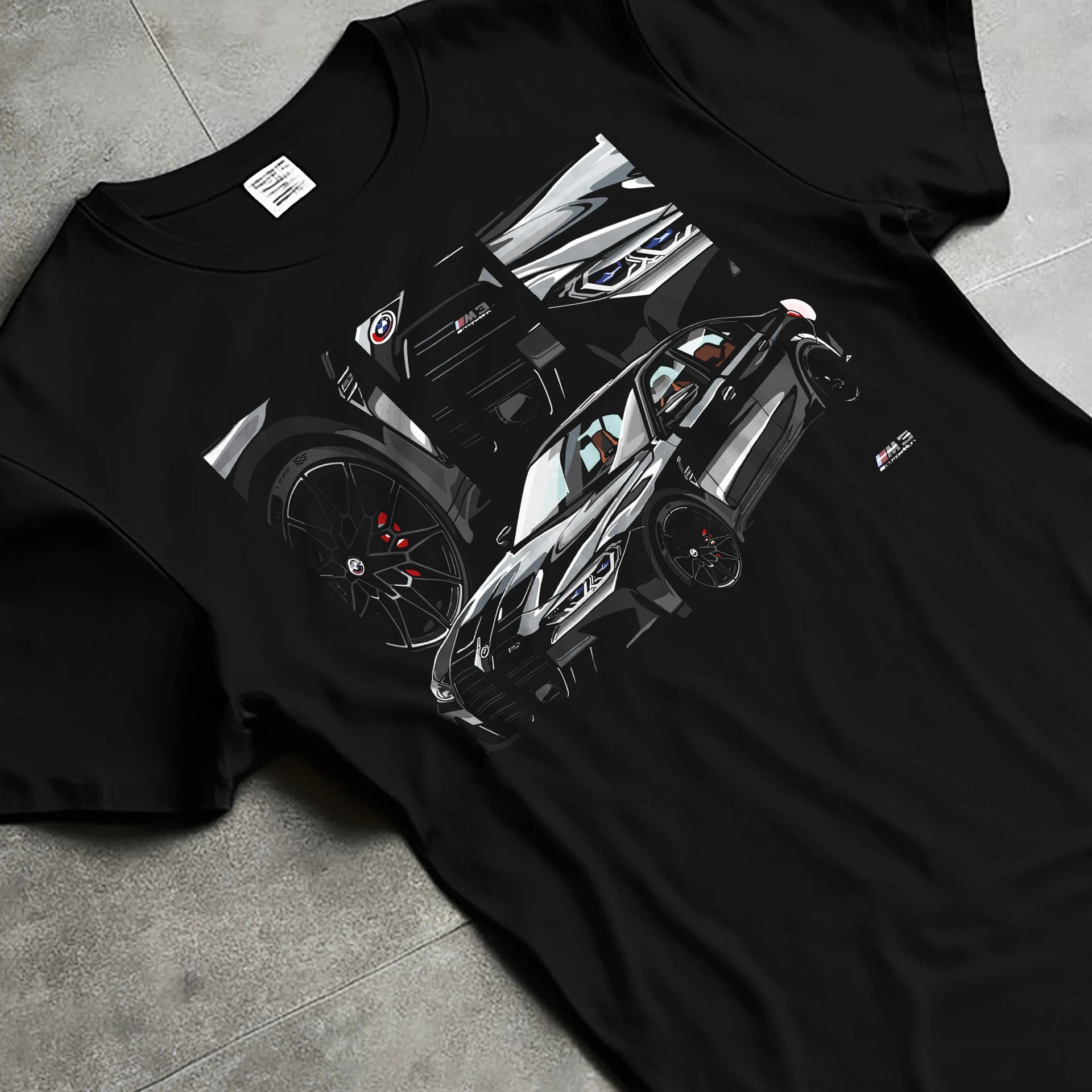 Black T-shirt laid flat with natural fabric folds, featuring BMW M3 rs motorsport german racing street performance graphic.