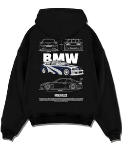 Black pullover hoodie laid flat on a white background, featuring BMW racing drift german tuner enthusiast street graphic.