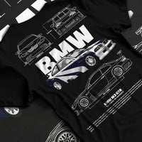 Black T-shirt laid flat with natural fabric folds, featuring BMW racing drift german tuner enthusiast street performance graphic.