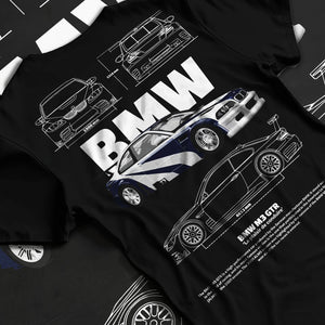 Black T-shirt laid flat with natural fabric folds, featuring BMW racing drift german tuner enthusiast street performance graphic.