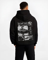 Black hoodie worn by a male model, back view, featuring BMW M4 german racing street performance motorsport automotive graphic.