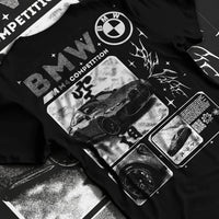 Black T-shirt laid flat with natural fabric folds, featuring BMW M4 german racing street performance motorsport automotive graphic.