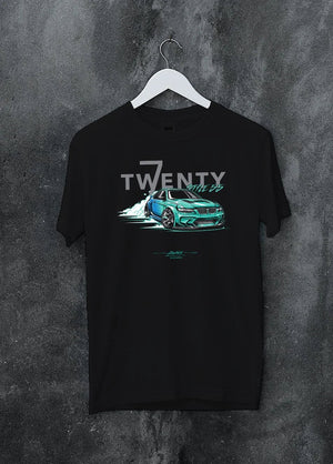 Black crewneck T-shirt on a hanger against a grey wall, featuring BMW turbo drift racing street performance motorsport graphic.