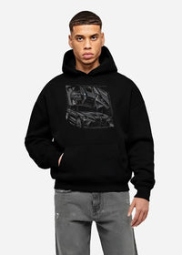 Black hoodie worn by a male model, front view, featuring BMW M4 german tuner street racing performance motorsport graphic.