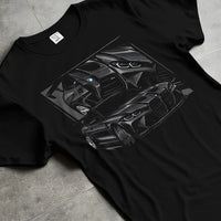 Black T-shirt laid flat with natural fabric folds, featuring BMW M4 german tuner street racing performance motorsport graphic.