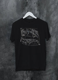 Black crewneck T-shirt on a hanger against a grey wall, featuring BMW M4 german tuner street racing performance motorsport graphic.