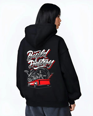 Black hoodie worn by a female model, back view, featuring racing street performance motorsport automotive enthusiast power graphic.