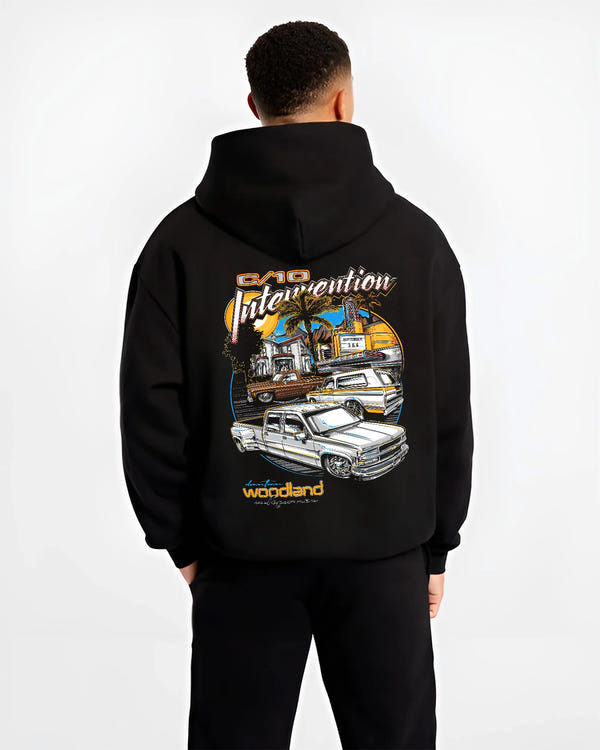Black hoodie worn by a male model, back view, featuring Chevrolet C10 retro vintage classic racing street performance graphic.