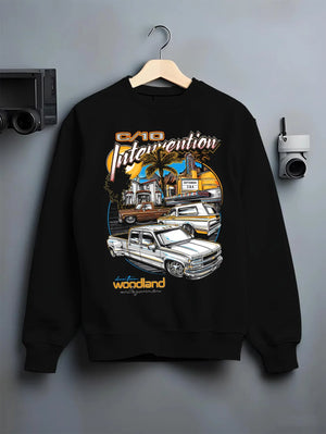 Black crewneck sweatshirt on a hanger against a grey wall, featuring Chevrolet C10 retro vintage classic racing street graphic.