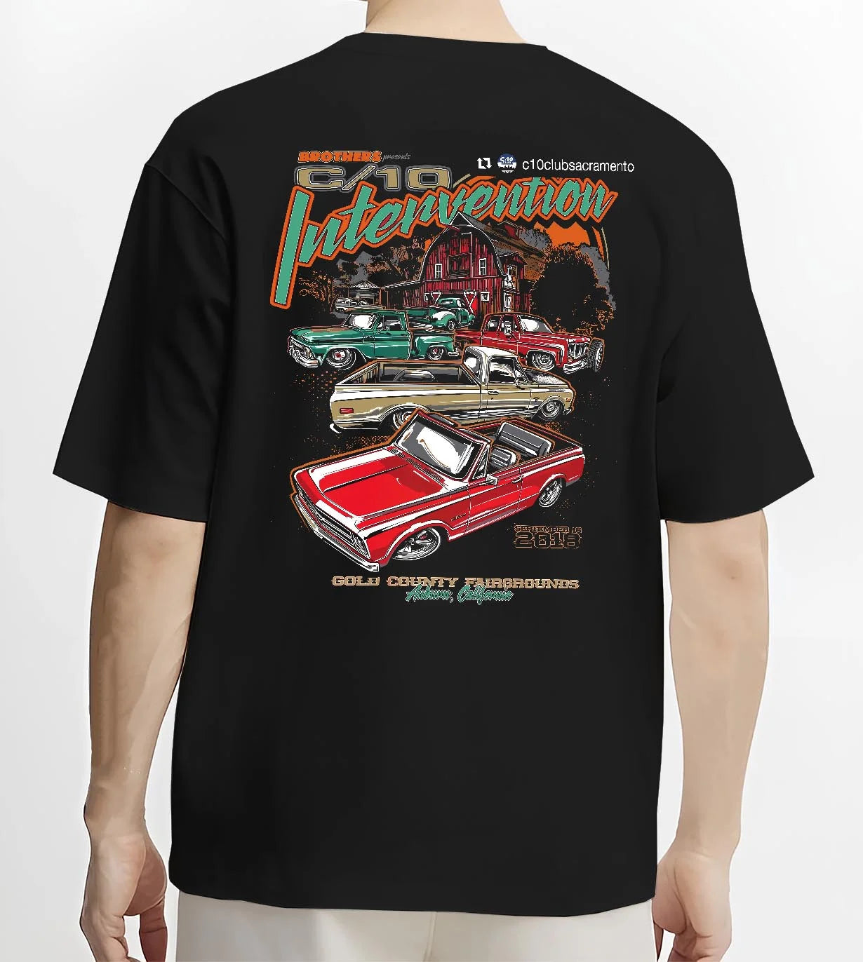 Black T-shirt worn by a male model, back view, featuring Chevrolet C10 vintage classic enthusiast meet racing street graphic.