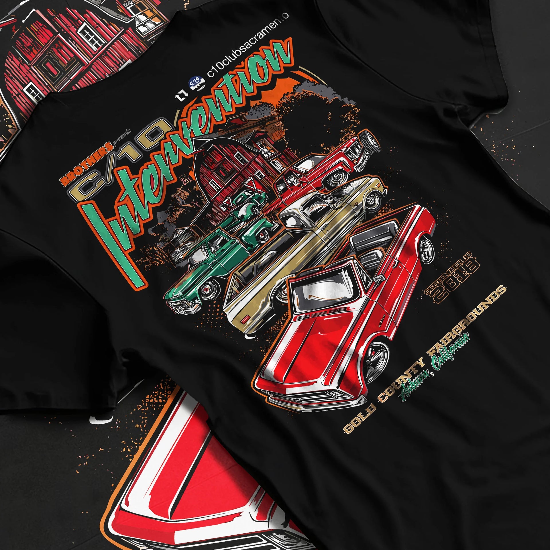 Black T-shirt laid flat with natural fabric folds, featuring Chevrolet C10 vintage classic enthusiast meet racing street graphic.