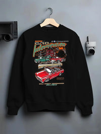 Black crewneck sweatshirt on a hanger against a grey wall, featuring Chevrolet C10 vintage classic enthusiast meet racing graphic.