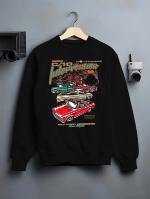 Black crewneck sweatshirt on a hanger against a grey wall, featuring Chevrolet C10 vintage classic enthusiast meet racing graphic.