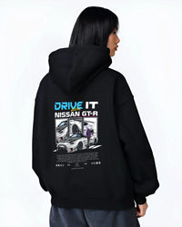 Black hoodie worn by a female model, back view, featuring muscle retro vintage classic enthusiast racing street performance graphic.