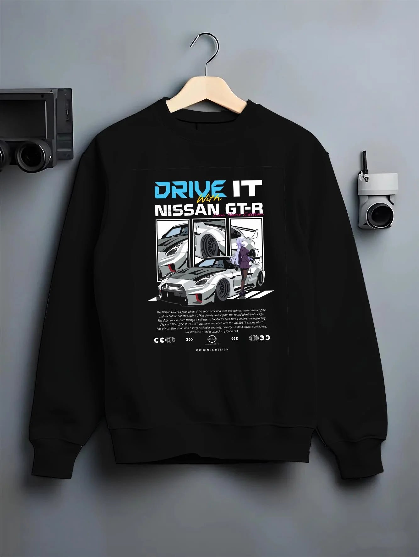 Black crewneck sweatshirt on a hanger against a grey wall, featuring muscle retro vintage classic enthusiast racing street graphic.