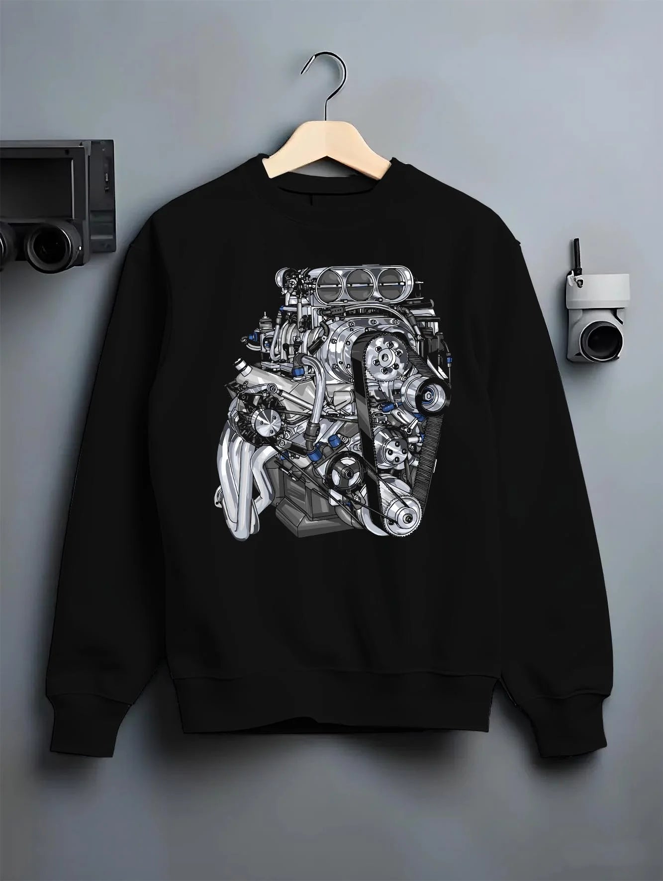 Black crewneck sweatshirt on a hanger against a grey wall, featuring turbo tuner street vintage enthusiast racing graphic.