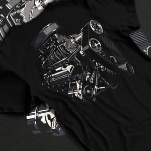 Black T-shirt laid flat with natural fabric folds, featuring street enthusiast racing performance motorsport automotive graphic.