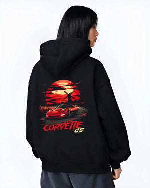 Black hoodie worn by a female model, back view, featuring Chevrolet Camaro racing drag american muscle street retro vintage graphic.