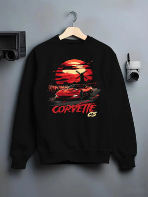 Black crewneck sweatshirt on a hanger against a grey wall, featuring Chevrolet Camaro racing drag american muscle street graphic.