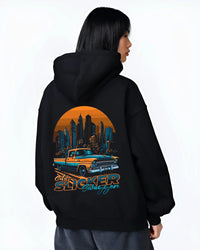 Black hoodie worn by a female model, back view, featuring Chevrolet SKYLINE retro vintage classic racing street performance graphic.