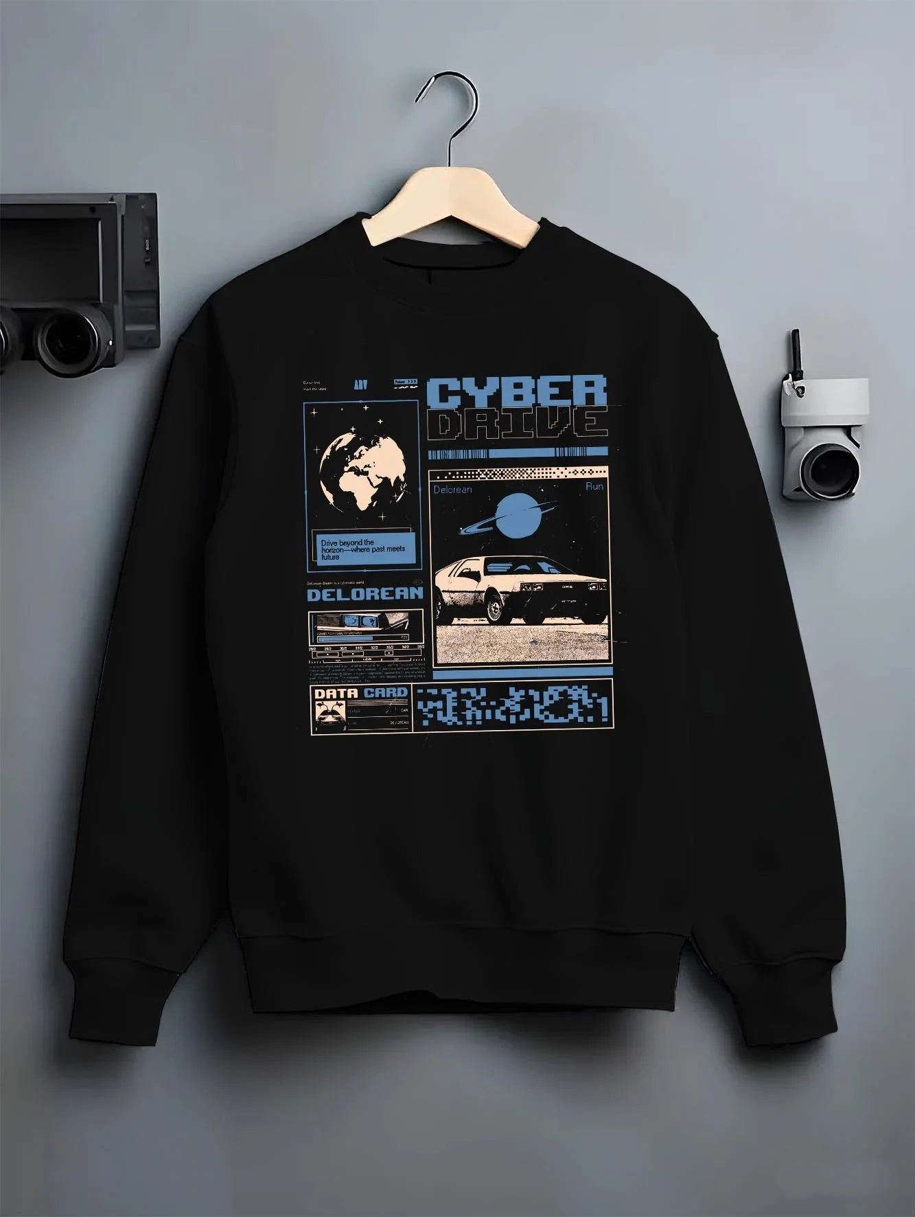 Black crewneck sweatshirt on a hanger against a grey wall, featuring DeLorean DMC-12 sti retro classic racing street graphic.