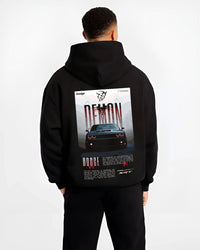 Black hoodie worn by a male model, back view, featuring Dodge Challenger racing muscle street retro enthusiast performance graphic.