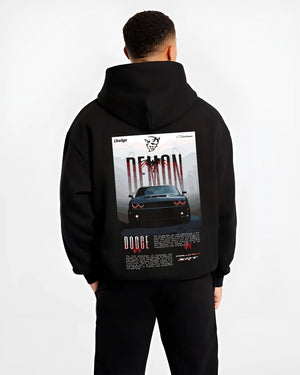 Black hoodie worn by a male model, back view, featuring Dodge Challenger racing muscle street retro enthusiast performance graphic.