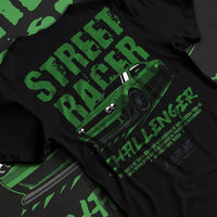 Black T-shirt laid flat with natural fabric folds, featuring Dodge Challenger racing race muscle street retro enthusiast graphic.