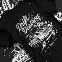 Black T-shirt laid flat with natural fabric folds, featuring racing drift street retro performance motorsport automotive graphic.