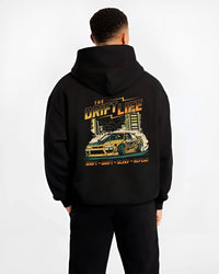 Black hoodie worn by a male model, back view, featuring racing drift jdm street retro vintage performance motorsport graphic.