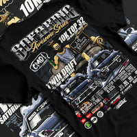 Black T-shirt laid flat with natural fabric folds, featuring racing drift jdm tuner street enthusiast show performance graphic.