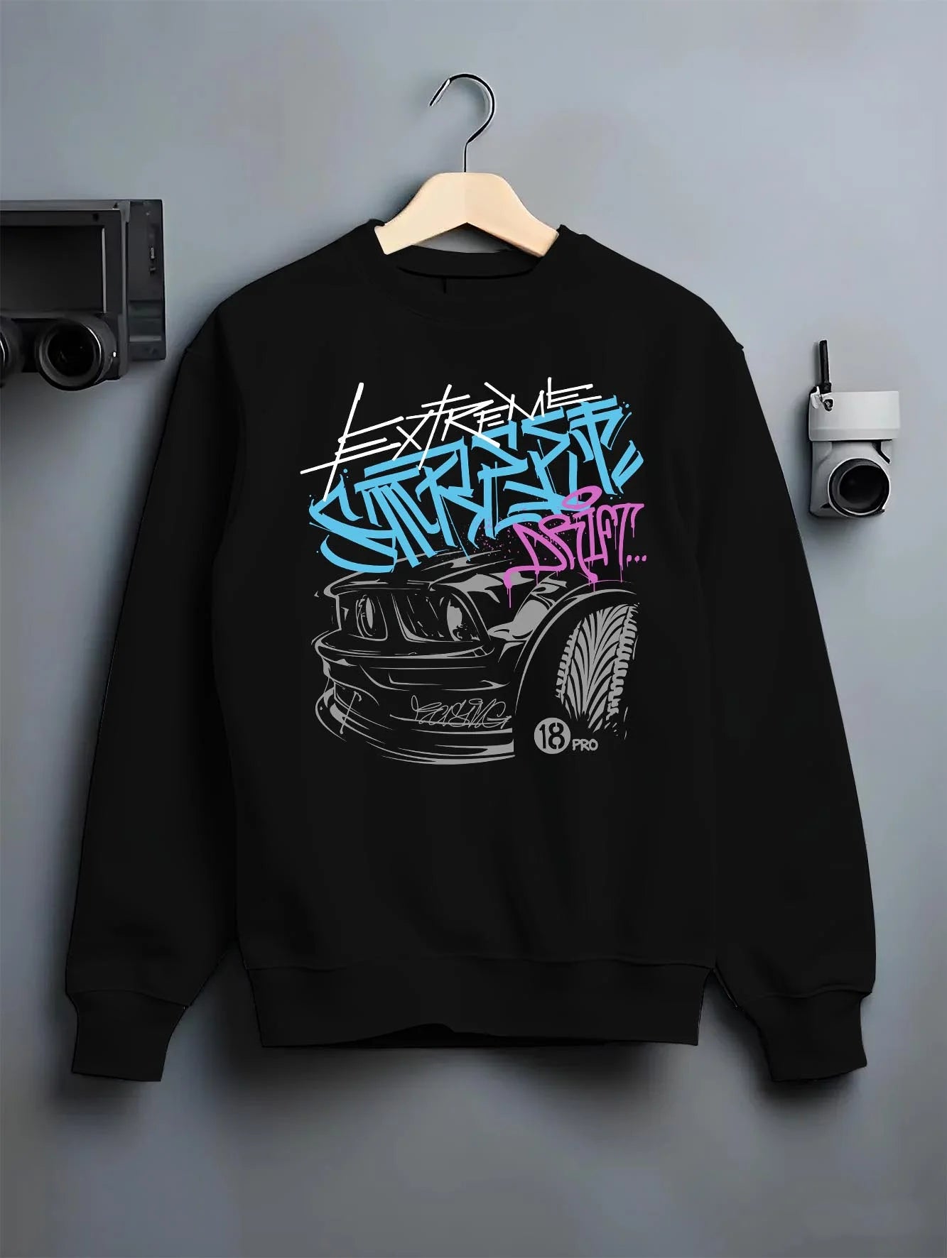 Black crewneck sweatshirt on a hanger against a grey wall, featuring drift jdm tuner street enthusiast racing performance graphic.