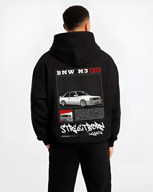 Black hoodie worn by a male model, back view, featuring BMW rs turbo racing drift motorsport euro street retro classic graphic.