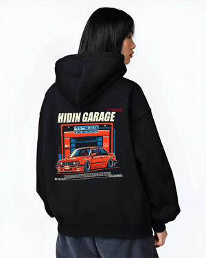 Black hoodie worn by a female model, back view, featuring BMW E30 racing drift jdm euro street retro classic graphic.