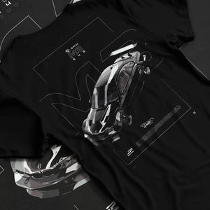 Black T-shirt laid flat with natural fabric folds, featuring BMW M3 gtr rs turbo racing le mans motorsport german street graphic.