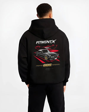 Black hoodie worn by a male model, back view, featuring BMW rs turbo ls racing motorsport euro street retro classic graphic.