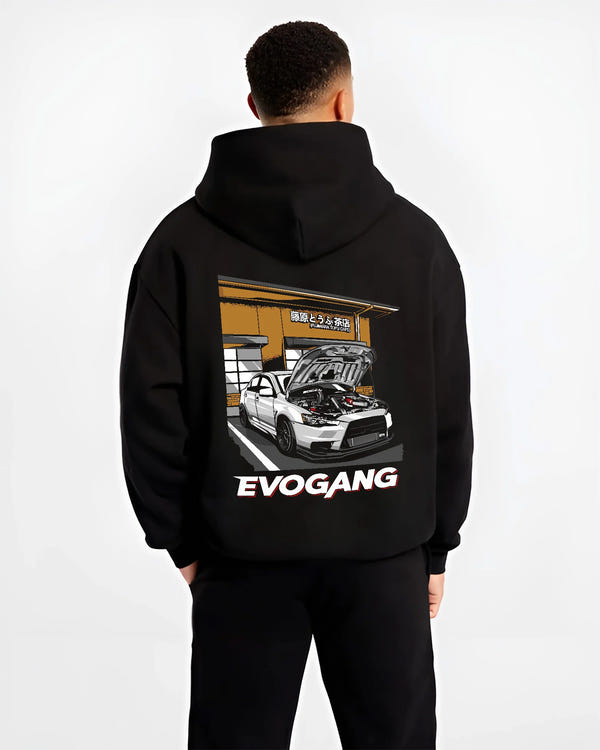 Black hoodie worn by a male model, back view, featuring Mitsubishi EVO rs racing jdm tuner street performance graphic.