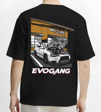 Black T-shirt worn by a male model, back view, featuring Mitsubishi EVO rs racing jdm tuner street performance graphic.