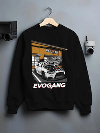 Black crewneck sweatshirt on a hanger against a grey wall, featuring Mitsubishi EVO rs racing jdm tuner street performance graphic.