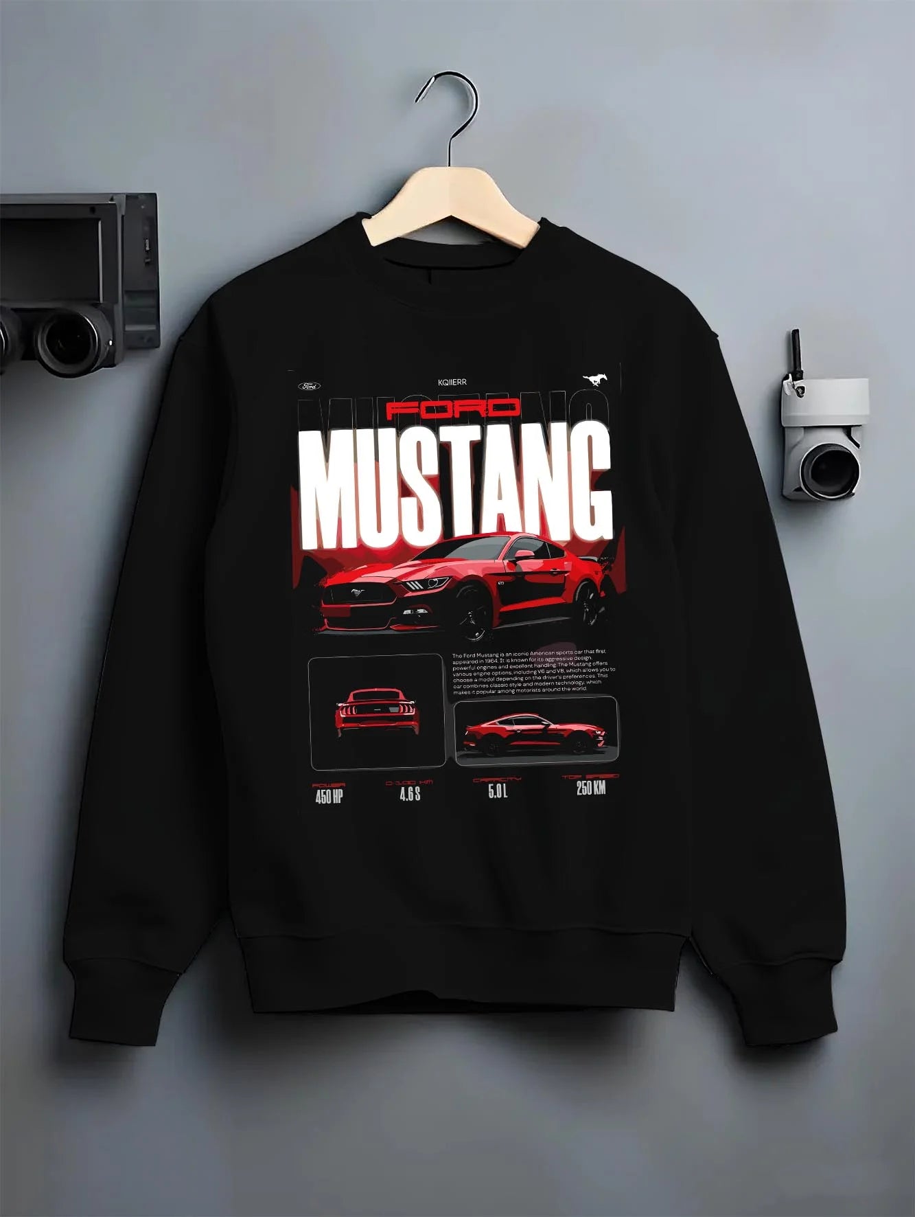 Black crewneck sweatshirt on a hanger against a grey wall, featuring Ford Mustang v8 american muscle street classic iconic graphic.