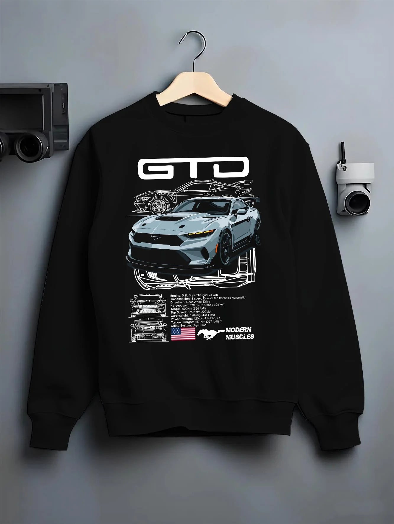 Black crewneck sweatshirt on a hanger against a grey wall, featuring MUSTANG supercharged v8 racing american muscle street graphic.