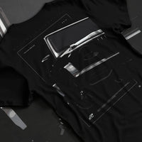 Black T-shirt laid flat with natural fabric folds, featuring Mercedes-Benz AMG rs racing street performance motorsport graphic.