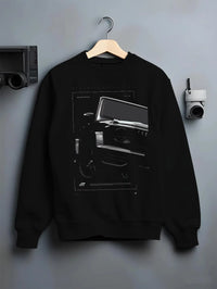 Black crewneck sweatshirt on a hanger against a grey wall, featuring Mercedes-Benz AMG rs racing street performance graphic.