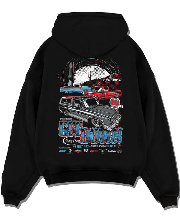 Black pullover hoodie laid flat on a white background, featuring Chevrolet retro vintage classic enthusiast show racing graphic.