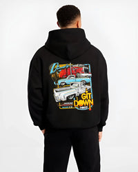 Black hoodie worn by a male model, back view, featuring street retro classic show racing performance motorsport automotive graphic.