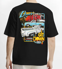 Black T-shirt worn by a male model, back view, featuring street retro classic show racing performance motorsport automotive graphic.