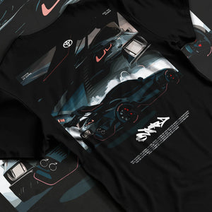 Black T-shirt laid flat with natural fabric folds, featuring Toyota Supra turbo turbocharged racing drift jdm japanese graphic.