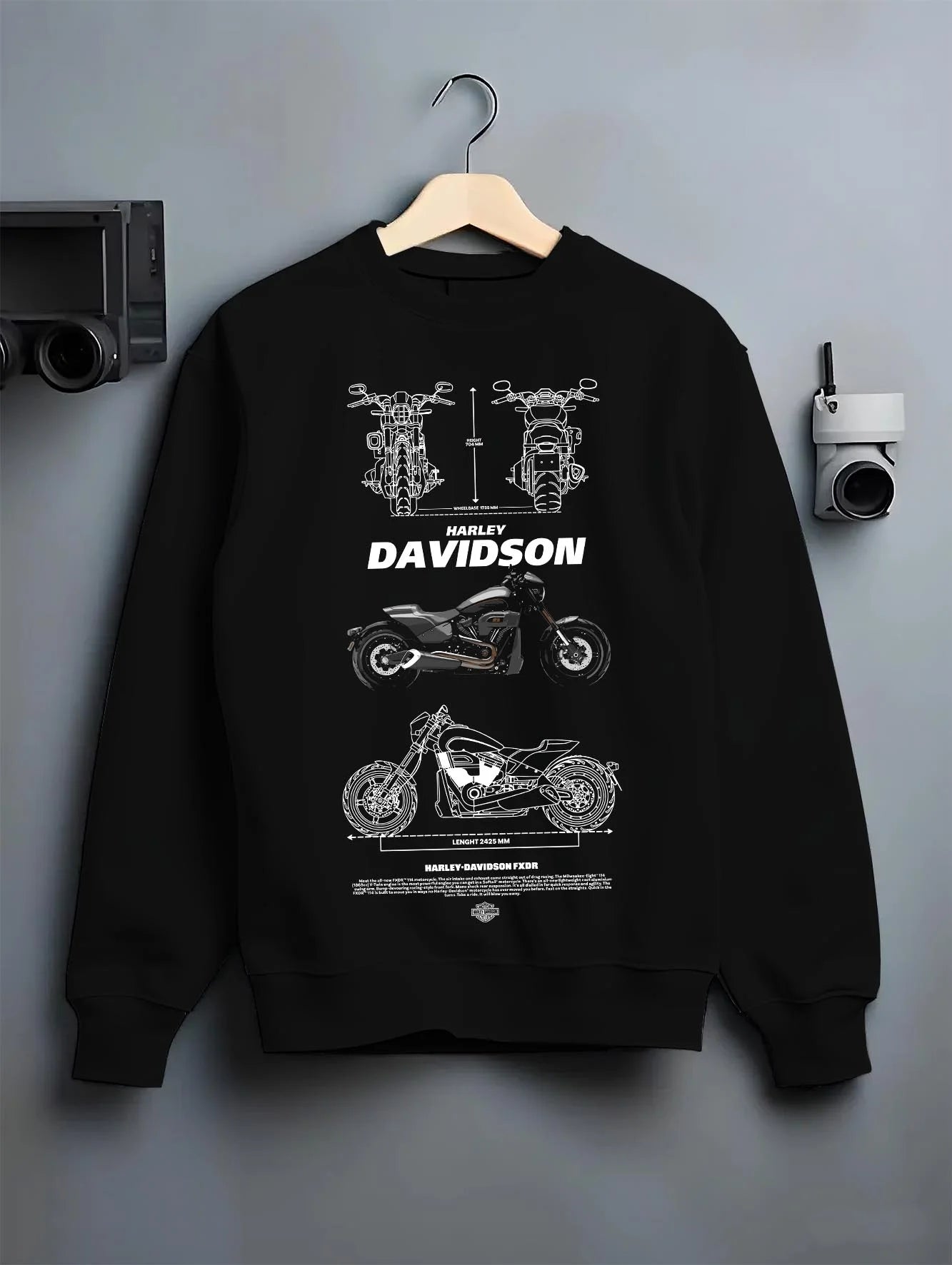 Black crewneck sweatshirt on a hanger against a grey wall, featuring Harley-Davidson Fxdr street retro enthusiast racing graphic.