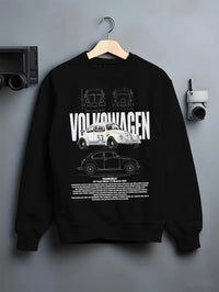 Black crewneck sweatshirt on a hanger against a grey wall, featuring Volkswagen Beetle racing classic legend street graphic.